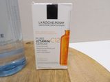 a bottle of water sitting on a table next to a bottle of vitamin c2