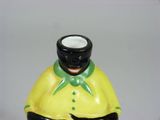 a yellow and black vase with a black man on it