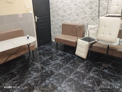 two chairs and a table in a room with a brick wall