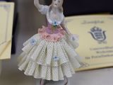 a small figurine of a woman in a dress on a table