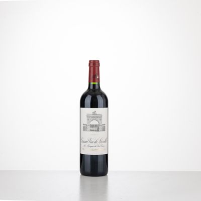 a bottle of red wine sitting on top of a table