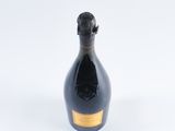 a bottle of champagne sitting on a white surface