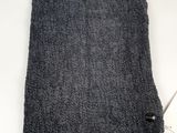 a gray towel sitting on top of a white table