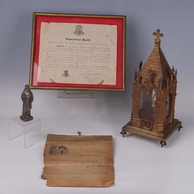 several pieces of art are displayed in a display case on a table