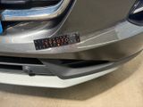 a close up of the front bumper of a car with a sticker on it
