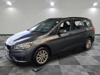 the bmw tourer is parked on a checkered tile floor