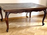 a wooden table that is sitting on a hard wood floor