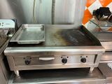 a stove with a pan on top of it in a kitchen