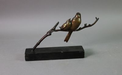 statue of a bird perched on a branch on a marble base