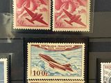 several stamps on display in a glass case on a black surface