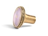 a close up of a ring with a purple stone on it