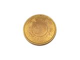 a close up of a gold coin on a white background