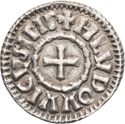 a silver coin with a cross in the center of it