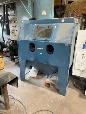 a machine that is sitting in a room with a lot of tools