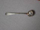 a silver spoon with a spoon handle on a table
