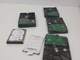 several hard drives are sitting on a table next to each other