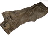 an old pair of brown pants sitting on top of a white surface