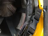 a close up of a yellow helmet with a black visor