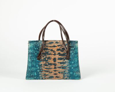 the small tote bag is made from recycled materials and has a leather handle