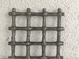 a metal rack that has a bunch of bamboo sticks on it