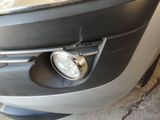 a close up of a car ' s front bumper with a light on