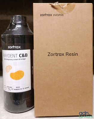 une bouteille de liquide posée à côté d'une boîte en carton