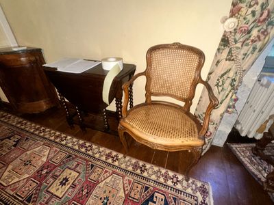 a chair that is next to a table with a book on it