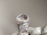 two bottles of wine wrapped in plastic wrap on a table