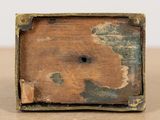 a wooden box with a hole in it on a table
