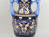 a large blue vase with a handle on a white background