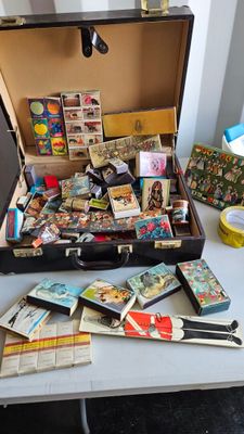 a suitcase full of cards and other items on a table