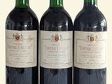 three bottles of wine sitting next to each other on a table