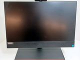 the monitor is sitting on a stand on a white surface