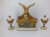 a gold statue of an angel sitting on top of a table