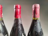three bottles of wine that are sitting on a table