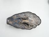 a silver plate with a horse on it on a white surface