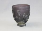 a purple vase with a design on it on a white surface