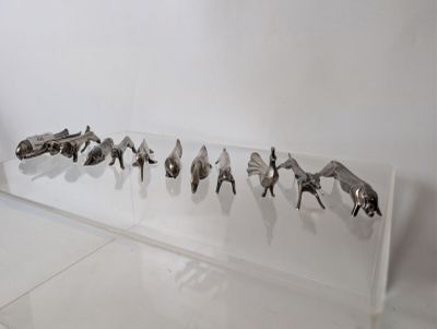 a display of various animal figurines on a clear shelf