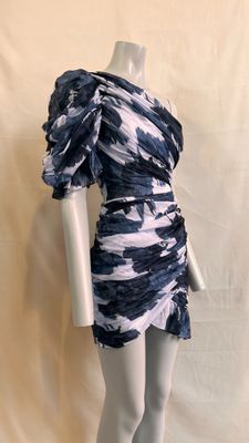 the mannequin is wearing a blue and white dress on a mannequin stand