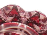 a close up picture of a red glass object