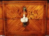 a wooden dresser with a floral design on it