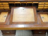 a wooden desk with a wooden top and drawers