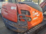 a small excavator that is parked in a lot