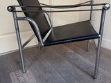 a black chair that is sitting on a hard wood floor