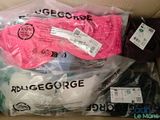 three pairs of gloves in a box with labels on them
