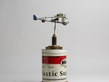 a toy airplane that is sitting on top of a can