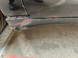 a close up of a car ' s bumper with a red marker on it