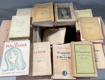 a lot of books that are stacked on top of each other