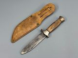 two knives are sitting next to each other on a table