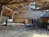 a large room with a wooden roof and a pile of rubble